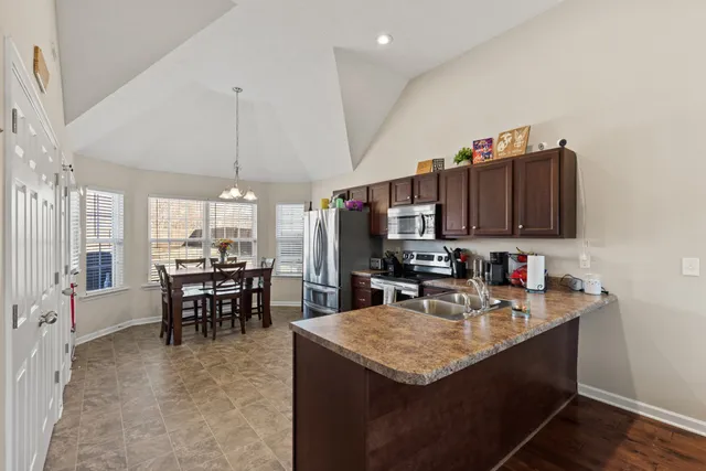 a kitchen with sink cabinets and dining table