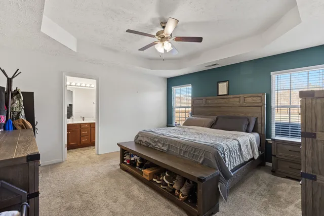 a bedroom with a bed and a chandelier
