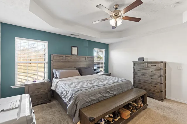 a bedroom with a bed and a chandelier