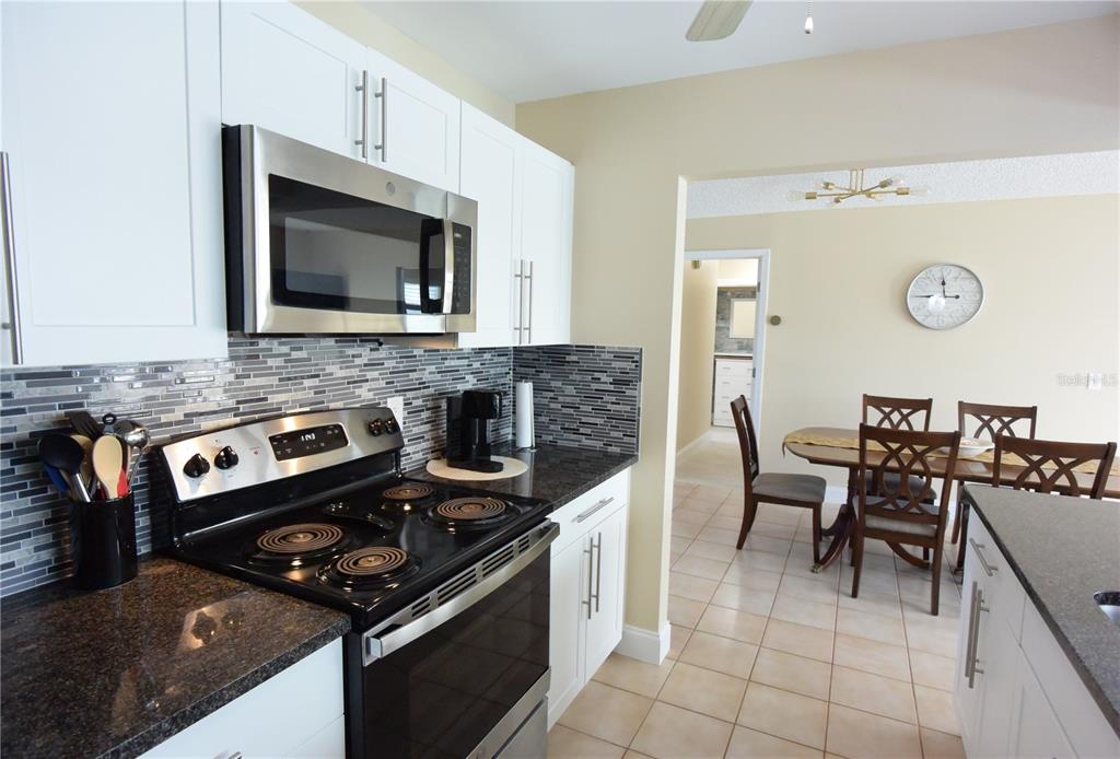 170 Argus Road Venice, FL 34293 - Photo 12 of 36 a kitchen with a stove and a microwave