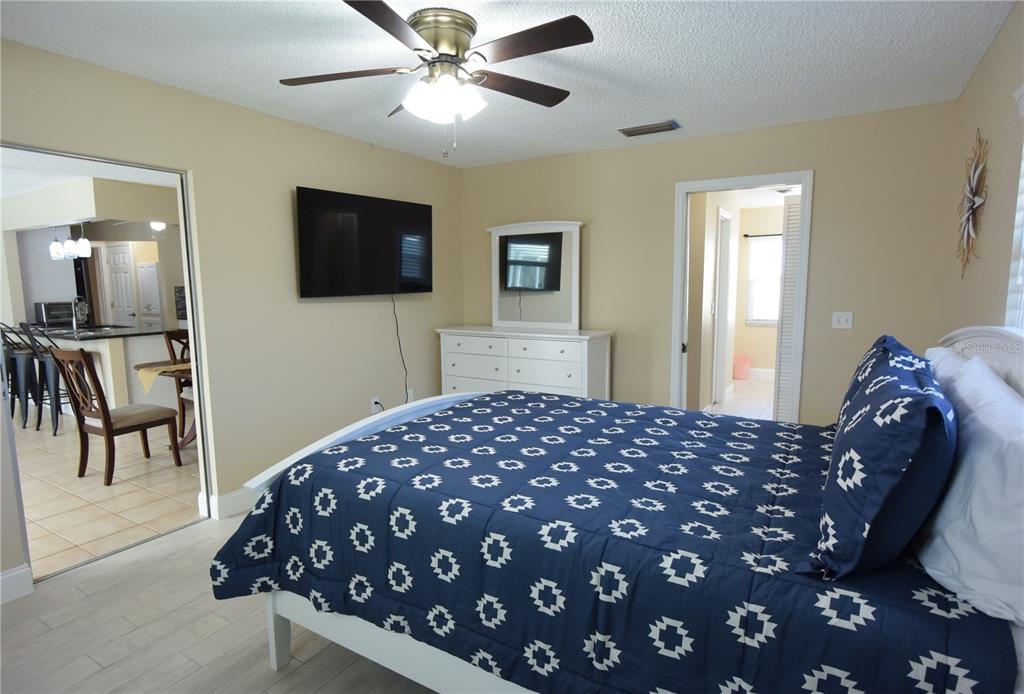 170 Argus Road Venice, FL 34293 - Photo 14 of 36 a bedroom with a bed and a flat screen tv