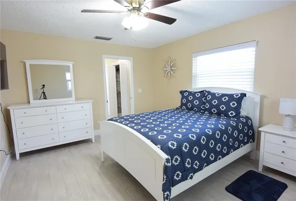 a bedroom with a bed and a dresser