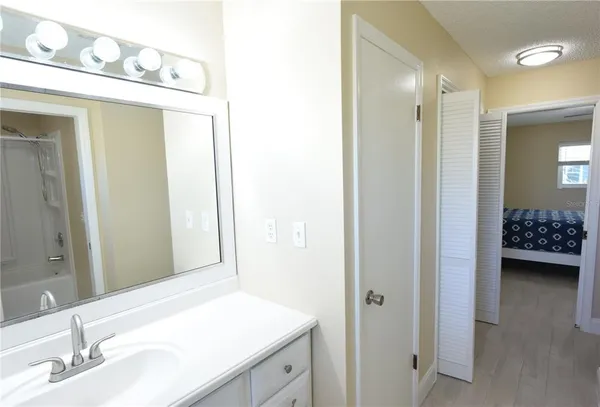 a en suite bathroom with a sink a mirror and a shower