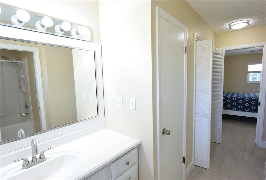 170 Argus Road Venice, FL 34293 - Photo 18 of 36 a en suite bathroom with a sink a mirror and a shower