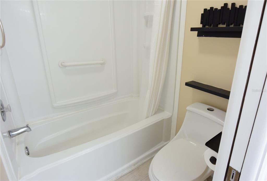 170 Argus Road Venice, FL 34293 - Photo 20 of 36 a bathroom with a toilet and a bathtub
