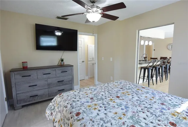 a bedroom with a bed and a flat screen tv