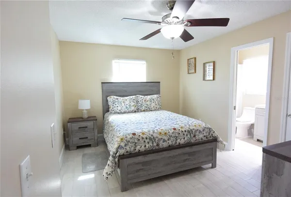 a bedroom with a bed and a chandelier