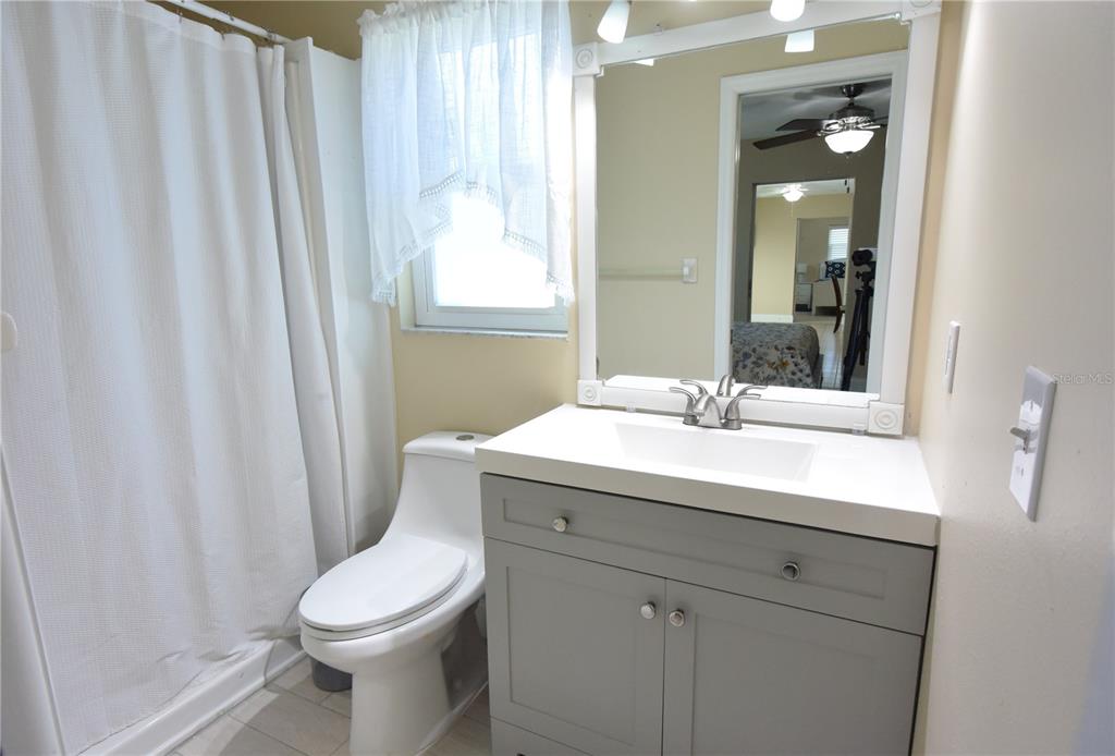 170 Argus Road Venice, FL 34293 - Photo 24 of 36 a bathroom with a sink a toilet and shower
