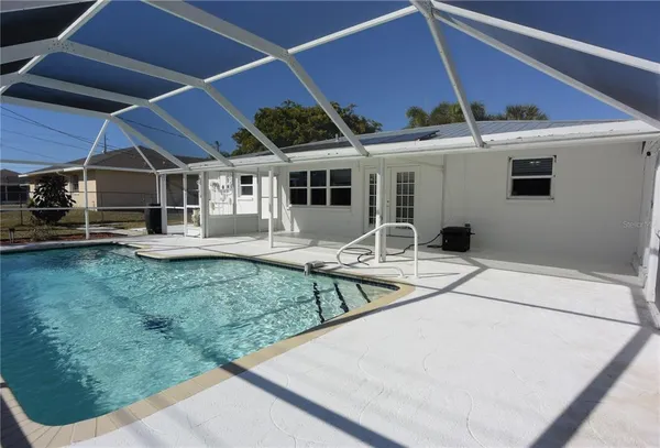 a view of a house with backyard porch and sitting area