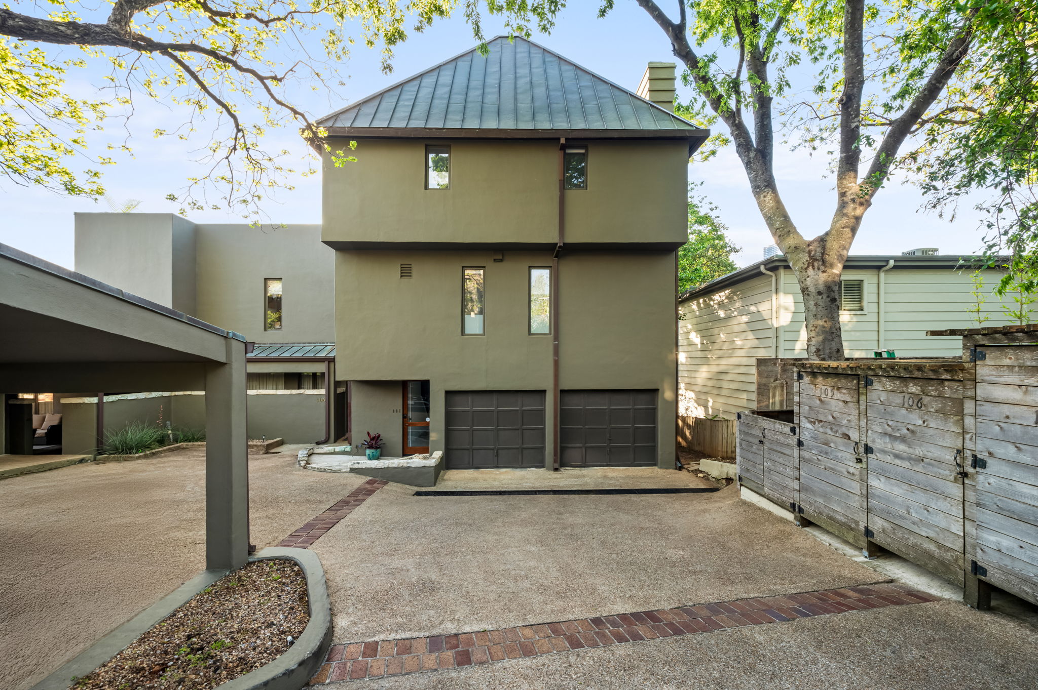 1111 West 12th Street, Unit 107 Austin, TX 78703 - Photo 38 of 38 Contemporary architecture featuring a metal roof and muted green exterior