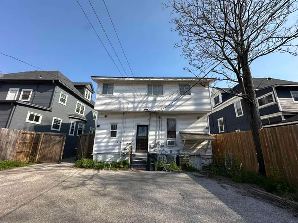 a view of a car park in front of house