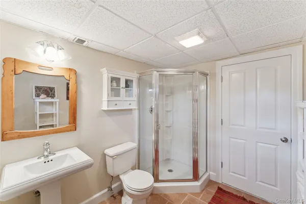 a bathroom with a toilet a sink and shower