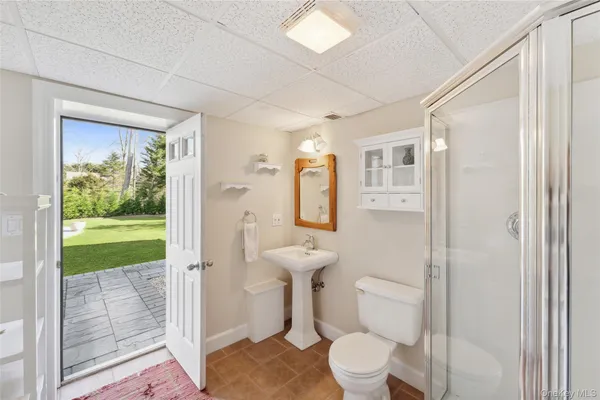 a bathroom with a toilet sink and a shower