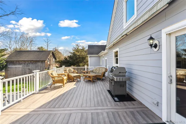 a view of a deck with couches and wooden floor
