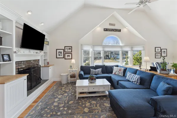 a living room with fireplace furniture and a flat screen tv