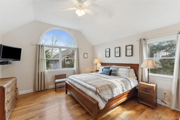 a bedroom with a large bed and a chandelier