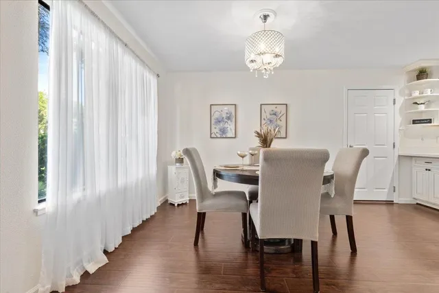 a view of a dining room with furniture and wooden floor