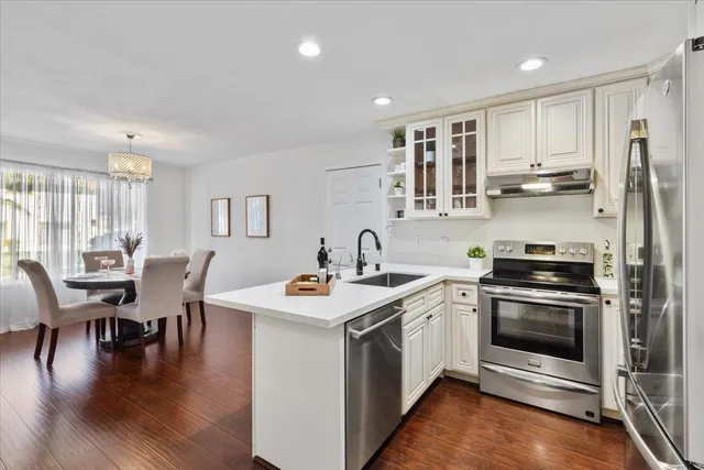 a kitchen with a stove a sink and a refrigerator