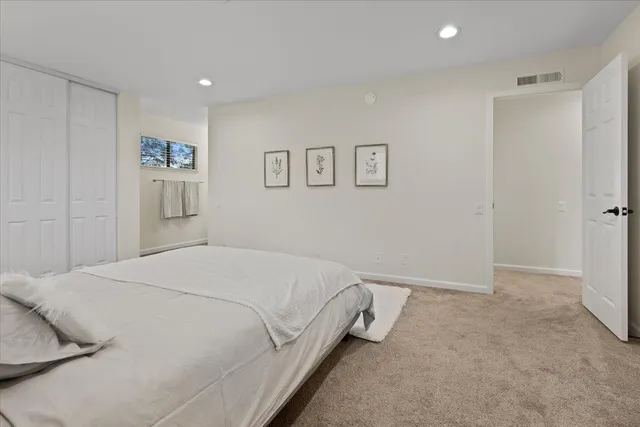 a bed room with a bed and a painting