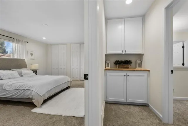a bedroom with a bed and cabinets