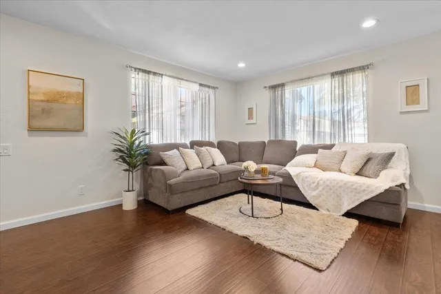 a living room with furniture and wooden floor