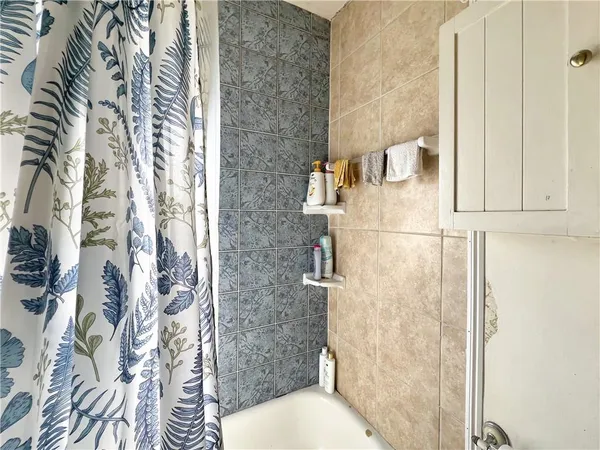 a bathroom with a toilet and shower