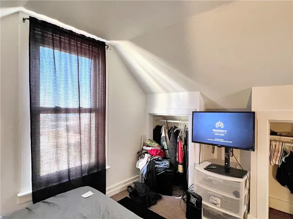 a bed sitting in a bedroom next to a window