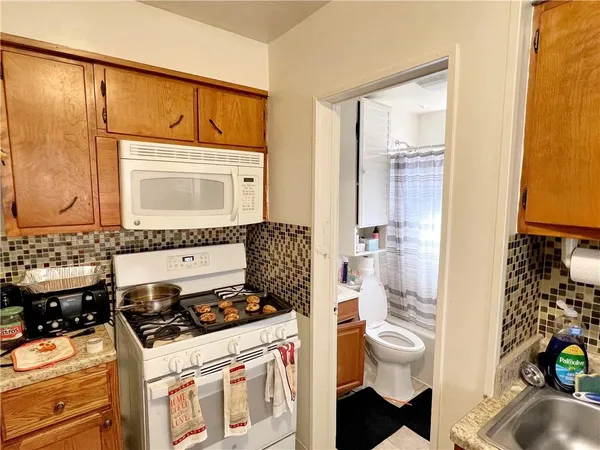 a kitchen with a stove a sink and a refrigerator