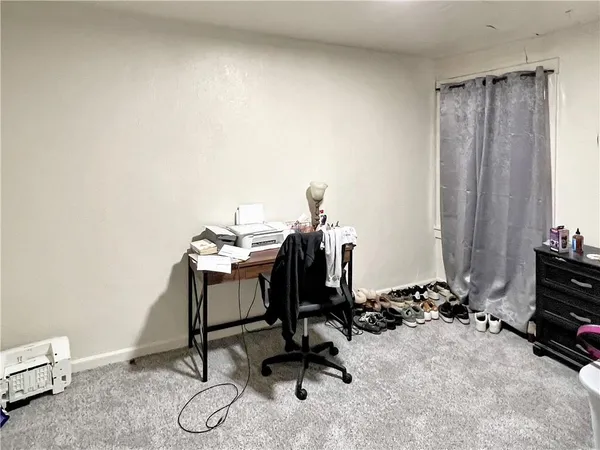 a view of a workspace with furniture and gym equipment