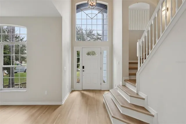 a view of entryway and hall with wooden floor