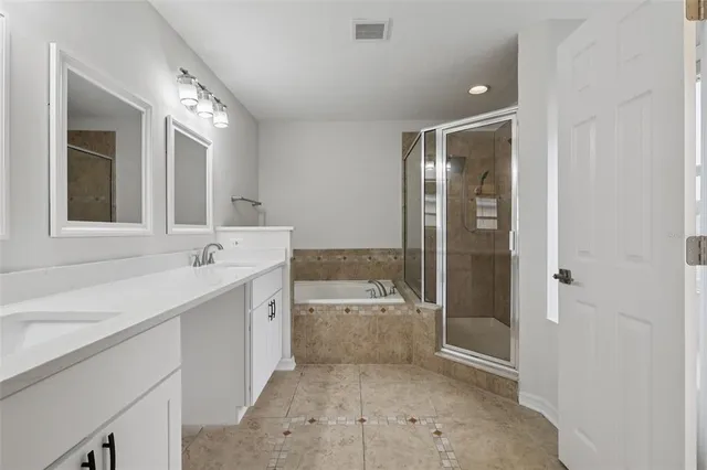 an empty room with a window and a ceiling fan