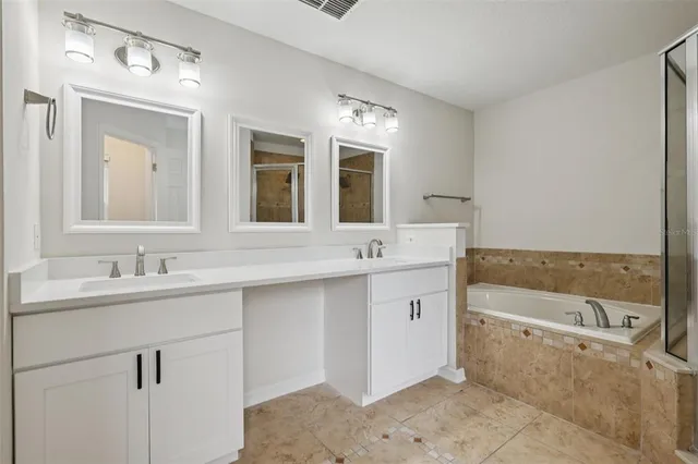 an empty room with wooden floor closet and fan