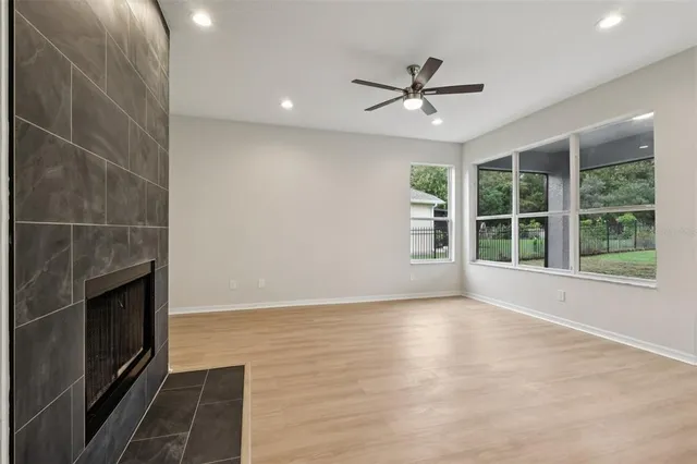 a kitchen with stainless steel appliances granite countertop a sink a oven a stove and a wooden floors