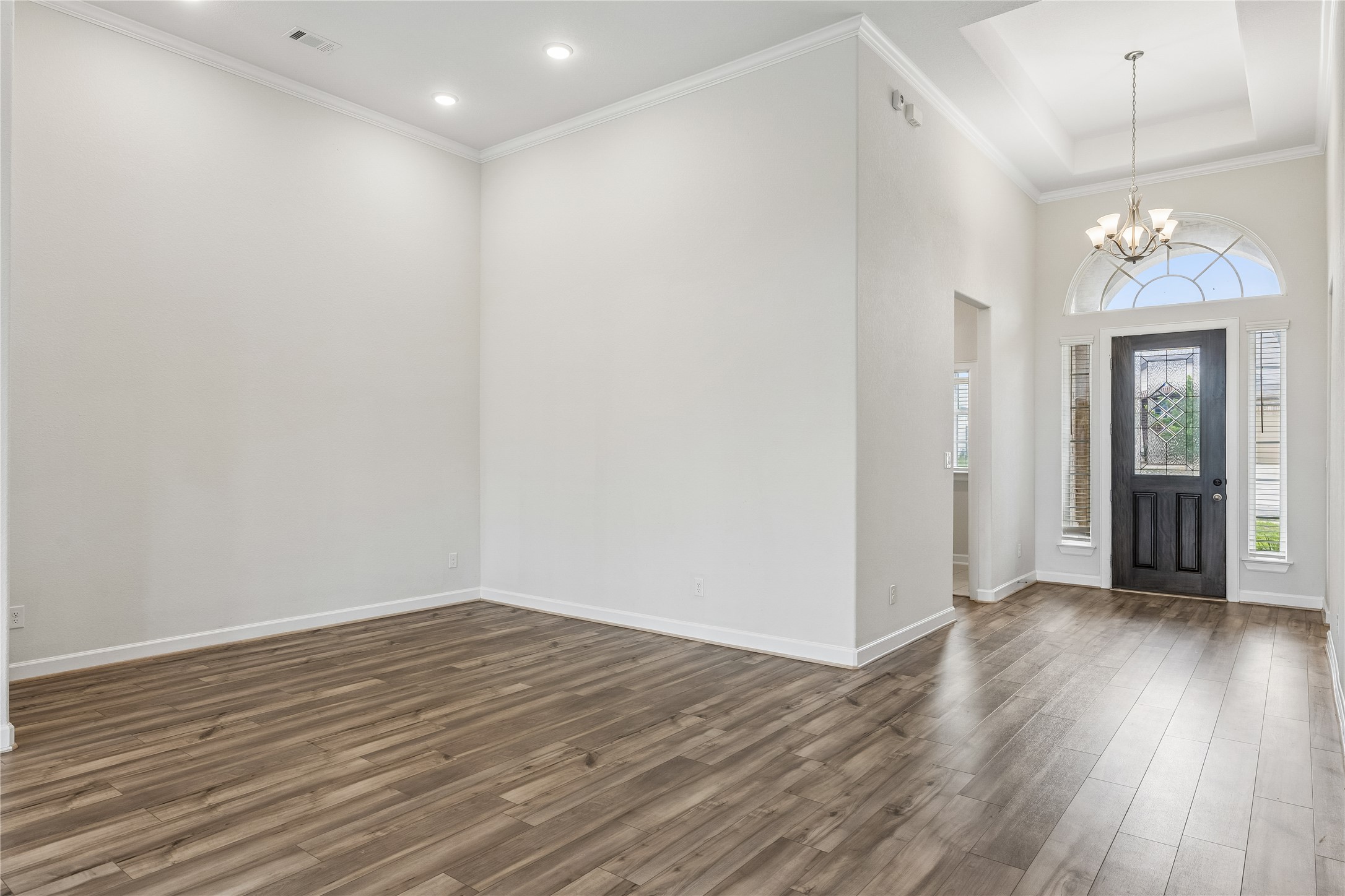 298 Wild Pecan Loop Buda, TX 78610 - Photo 5 of 40 wooden floor in an empty room with a window