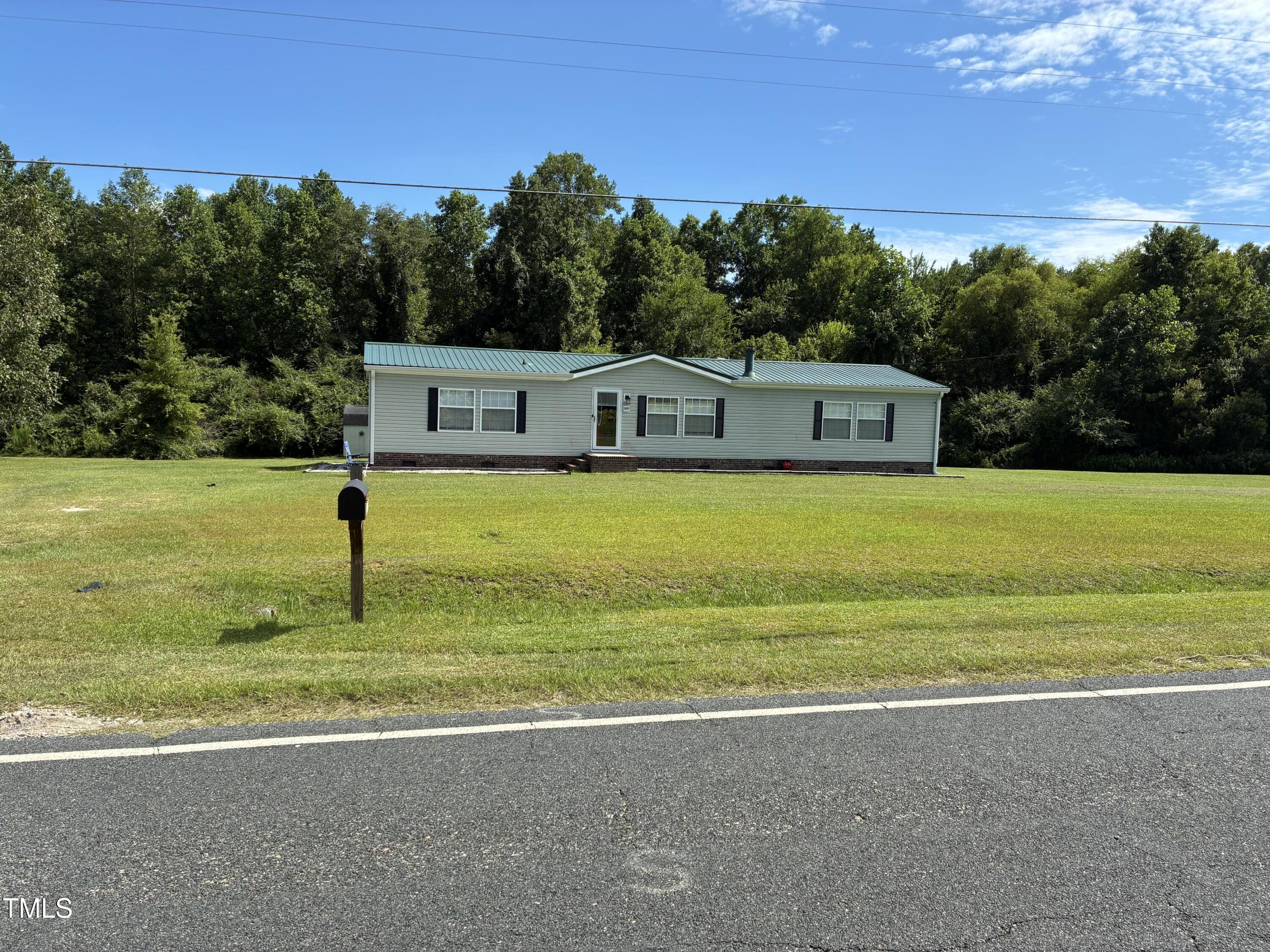 2455 McLean Chapel Church Road Bunnlevel, NC 28323 - Photo 1 of 21 a front view of a house with a yard