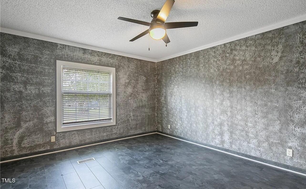 2455 McLean Chapel Church Road Bunnlevel, NC 28323 - Photo 18 of 21 an empty room with a window and a ceiling fan