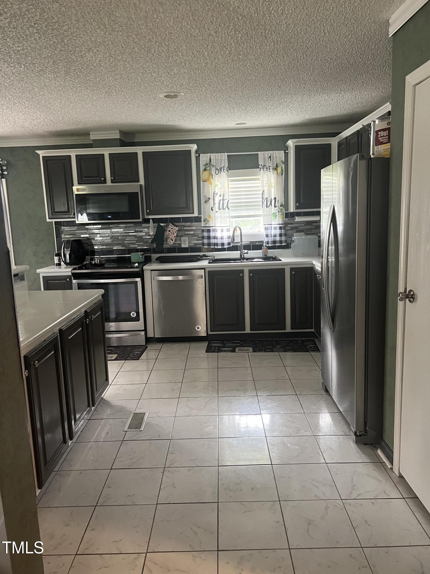 2455 McLean Chapel Church Road Bunnlevel, NC 28323 - Photo 3 of 21 a large kitchen with a stove top oven microwave and cabinets