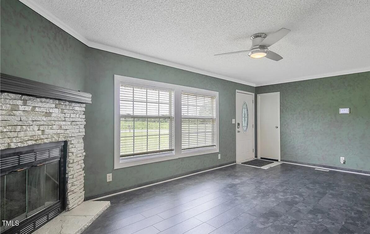 2455 McLean Chapel Church Road Bunnlevel, NC 28323 - Photo 8 of 21 a view of an empty room with a fireplace and a window