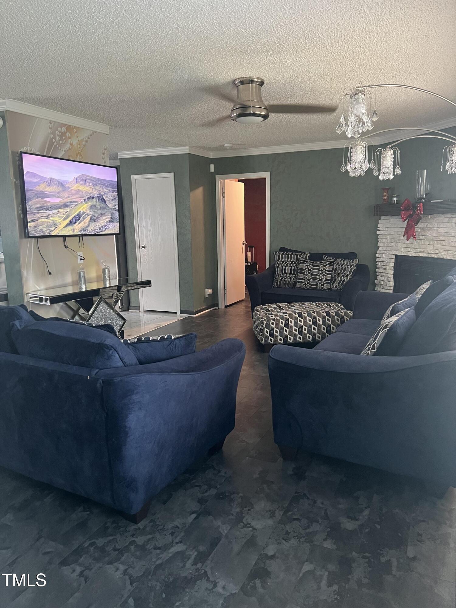 2455 McLean Chapel Church Road Bunnlevel, NC 28323 - Photo 10 of 21 a living room with furniture and a chandelier