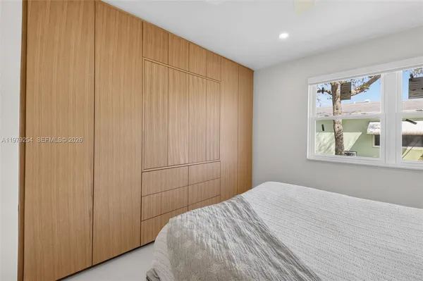 a bedroom with a bed and a window