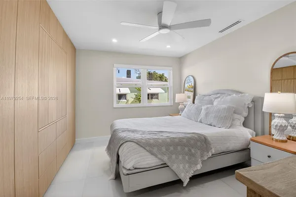 a bedroom with a bed and lamp