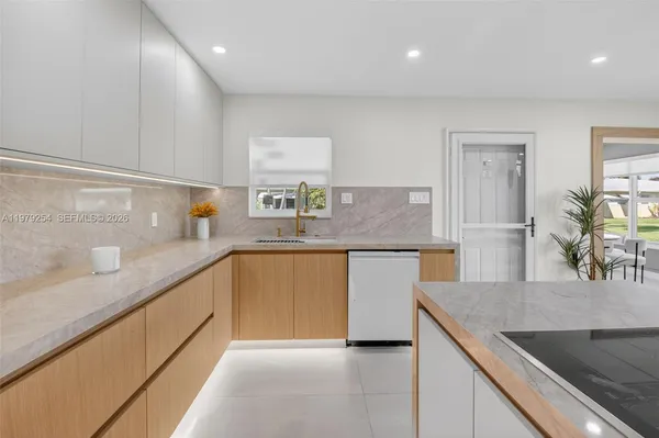 a kitchen with stainless steel appliances granite countertop a sink a stove and a refrigerator