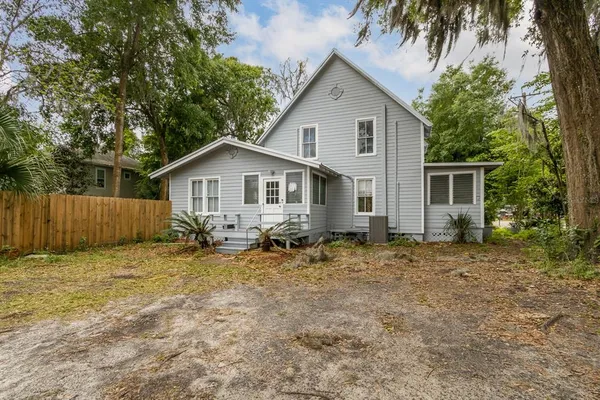 a view of backyard of house with seating space