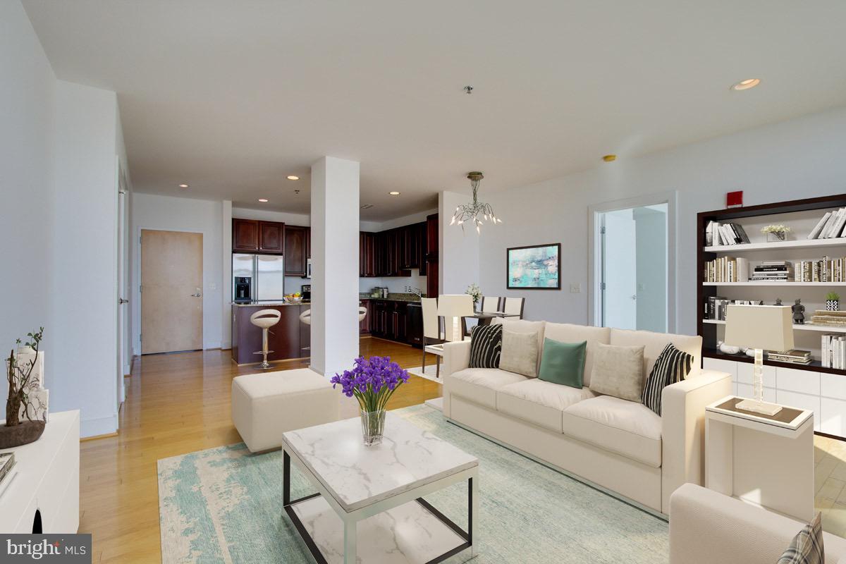 2772 Lighthouse Point East, Unit 308 Baltimore, MD 21224 - Photo 3 of 6 a living room with furniture kitchen view and a flat screen tv