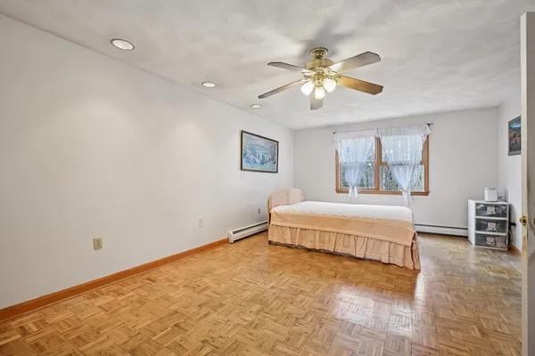 a spacious bedroom with a bed and a chandelier