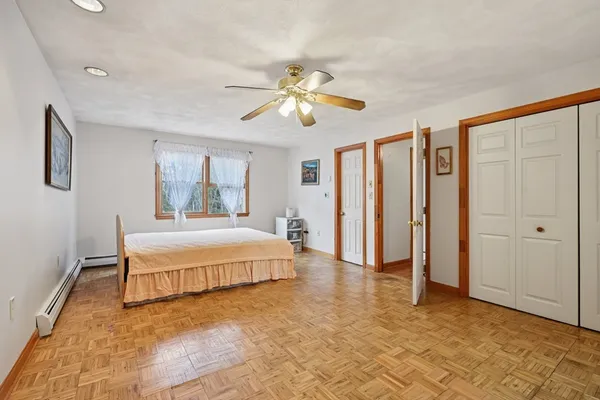 a spacious bedroom with a bed and a chandelier