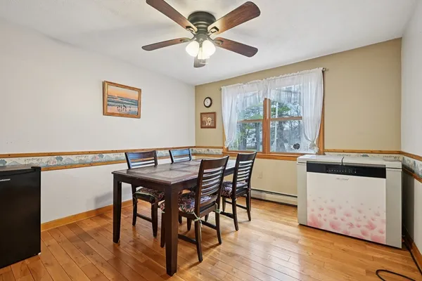 a view of a dining room with furniture window and wooden floor