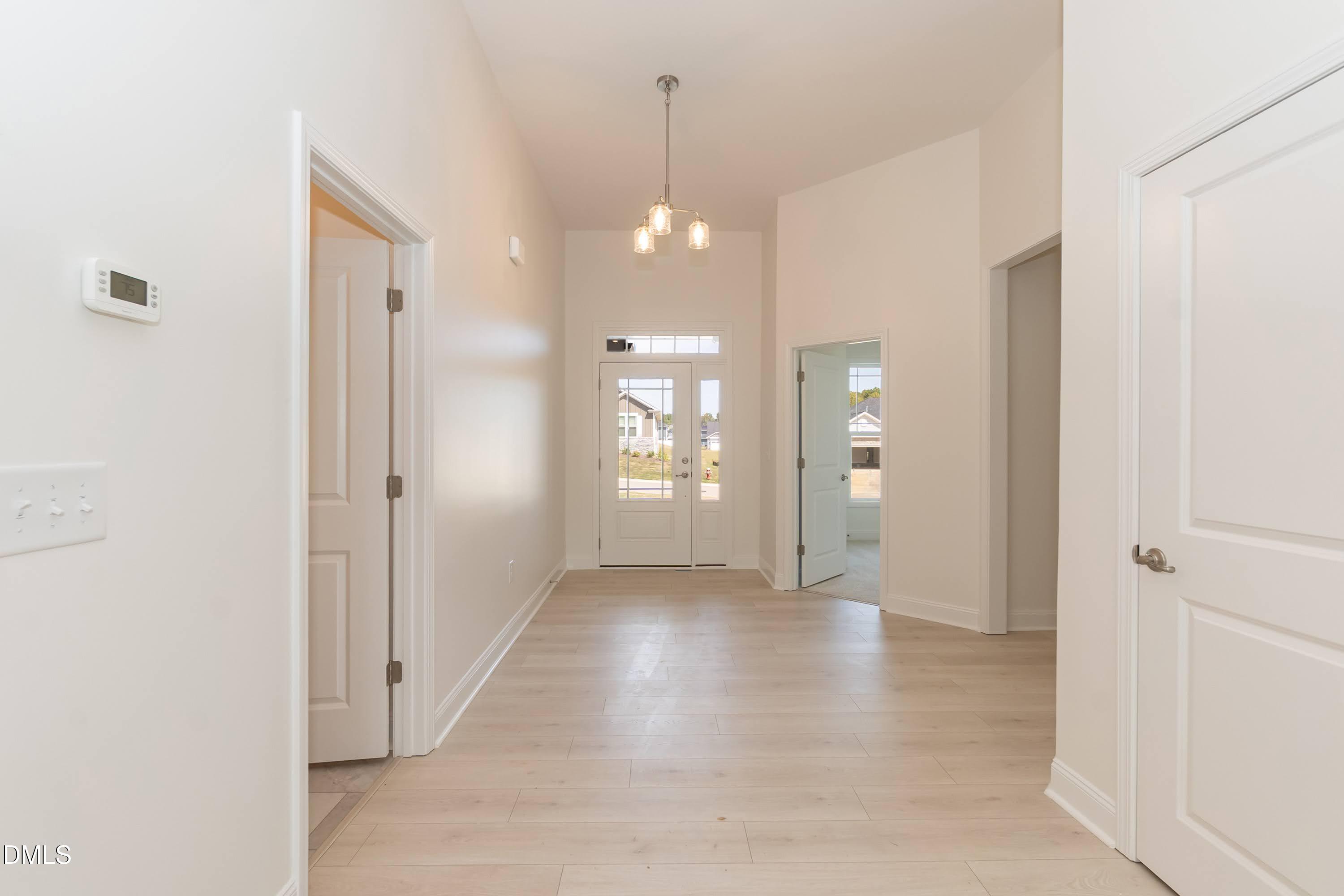 254 Galway Road Lillington, NC 27546 - Photo 4 of 35 a view of a hallway with wooden floor and a bathroom