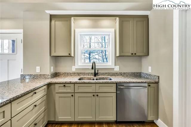 a kitchen with stainless steel appliances granite countertop a refrigerator sink and stove