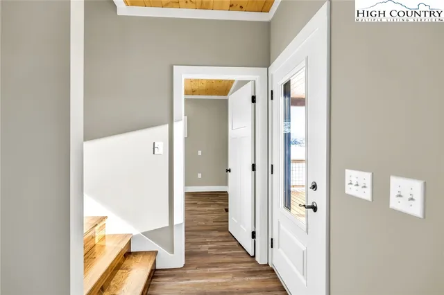 a view of a room with wooden floor